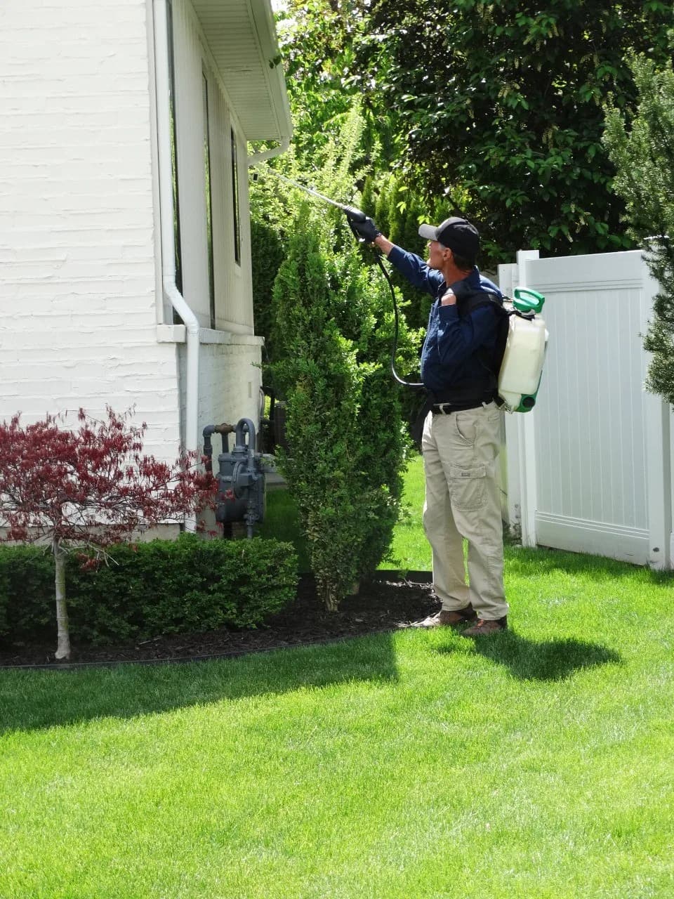 Reynolds technician applying treatment outside a customer's home