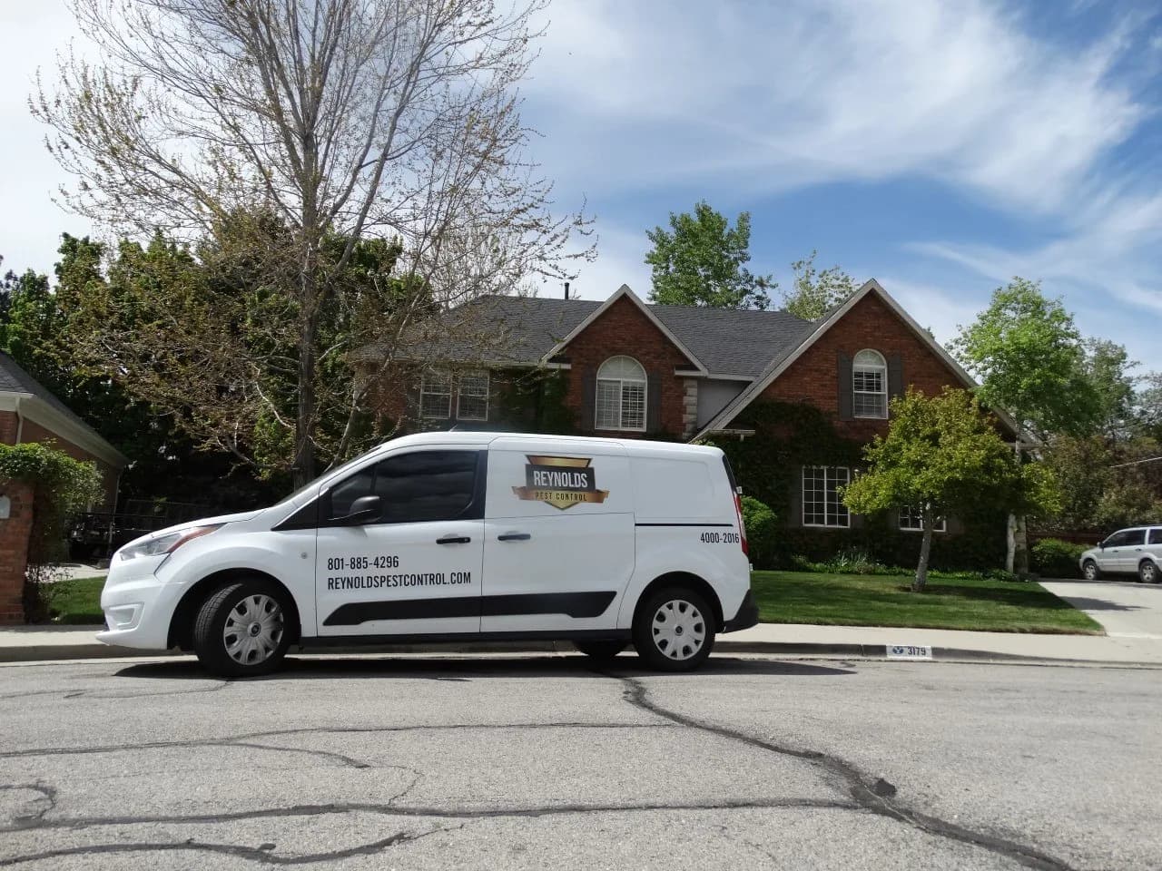 Reynolds Pest Control van parked outside a customer home