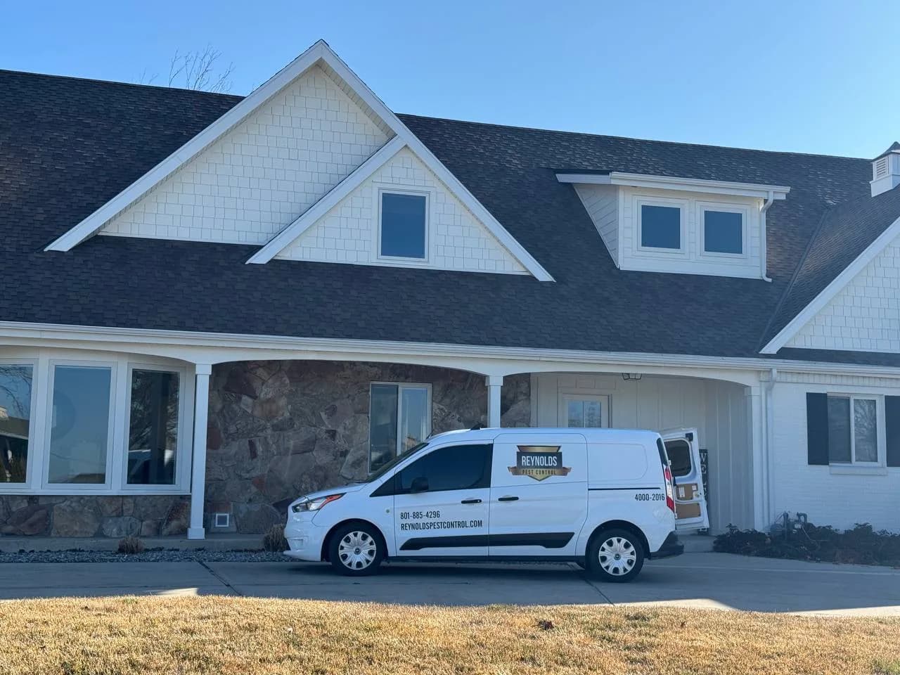 Reynolds Pest Control van parked outside a Utah County home